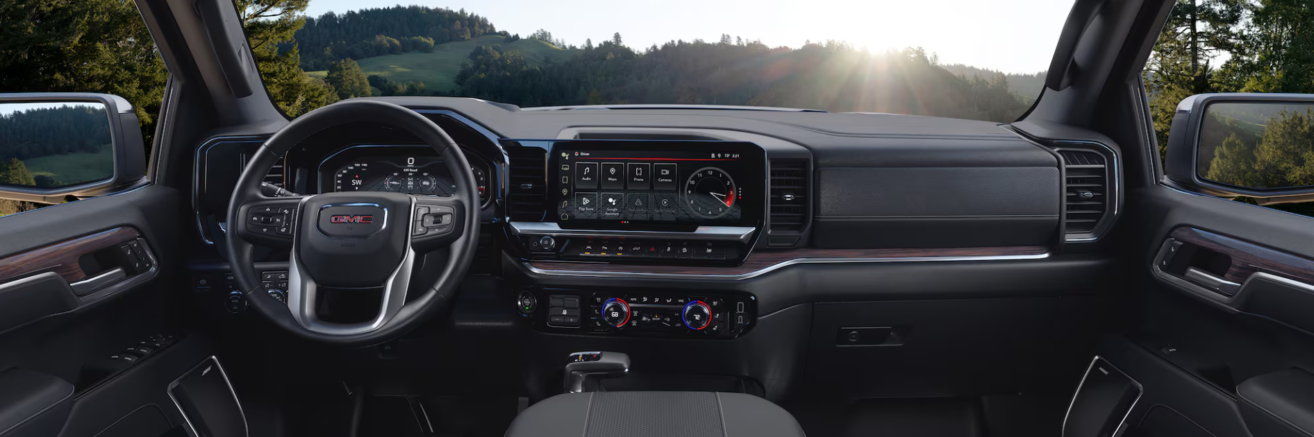 Interior of GMC Sierra with digital display and infotainment screen.