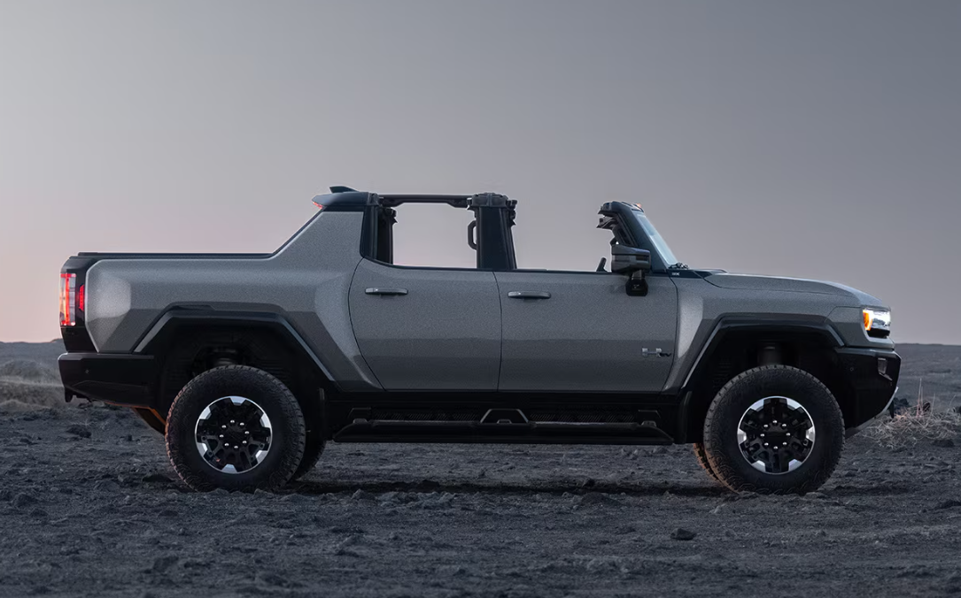 A 2026 GMC HUMMER EV Pickup with the roof panels removed, shown in a side profile.