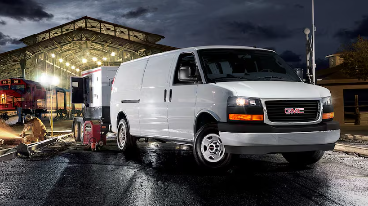 2026 GMC Savana Cargo Van in white parked at nighttime worksite