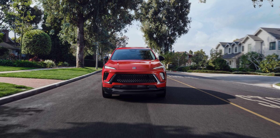 2026 Buick Envision driving in Cockeysville, MD near Anderson Buick GMC of Hunt Valley sleek red SUV front view